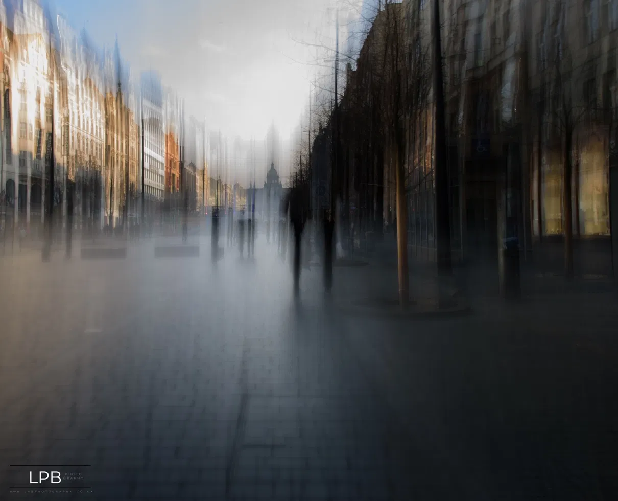 A boulevard melting upward toward a domed building