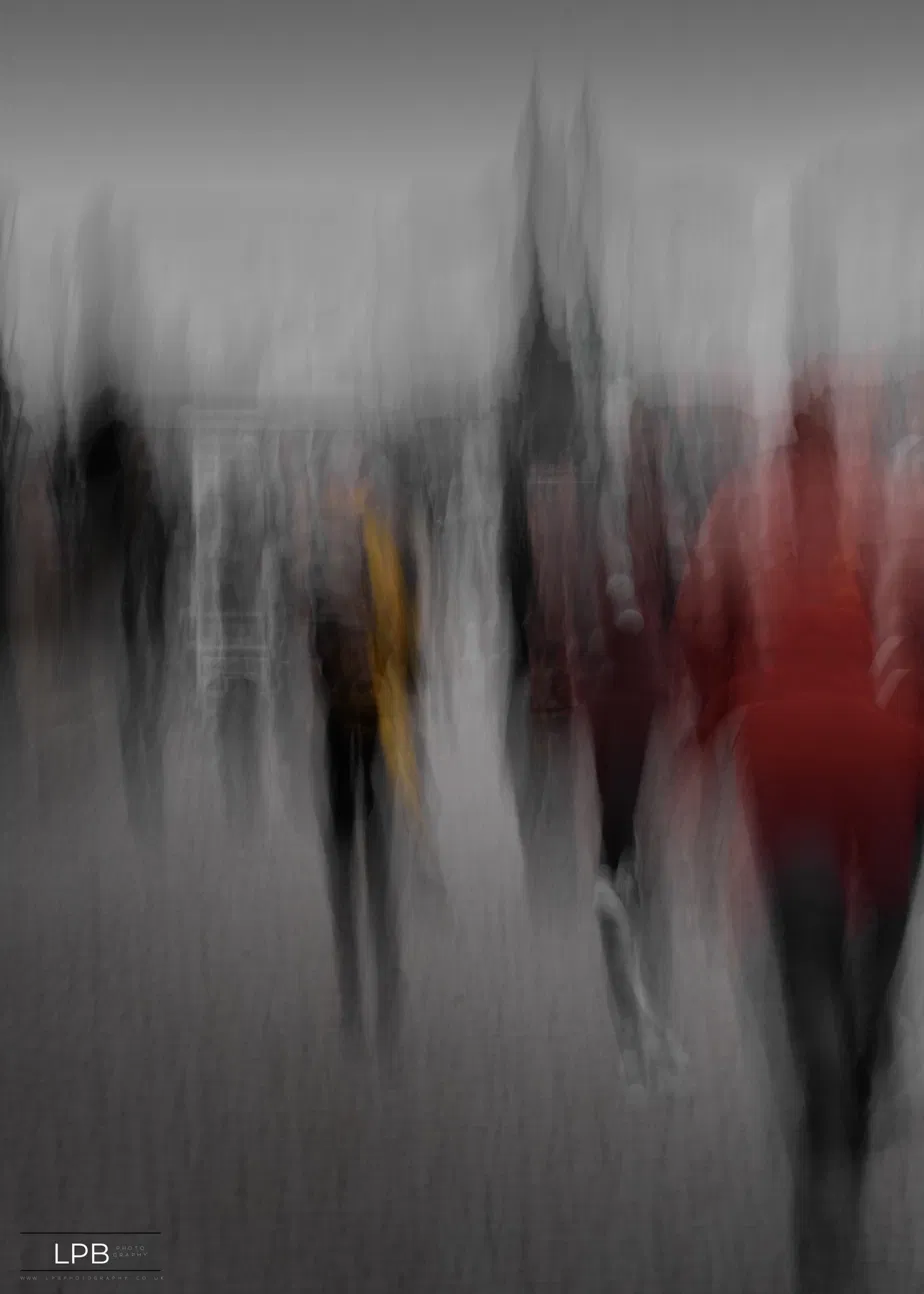 A figure dissolved into vertical streaks of motion on a city street